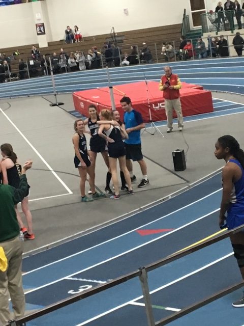 After the 4x400 girls relay, Bennett Nostrand, Gwyneth Fitzpatrick, Ava Cote, and Jake Sturim crowd sophomore Gaylan Ryuss who strong finish propelled the team to a medal and qualification in states.