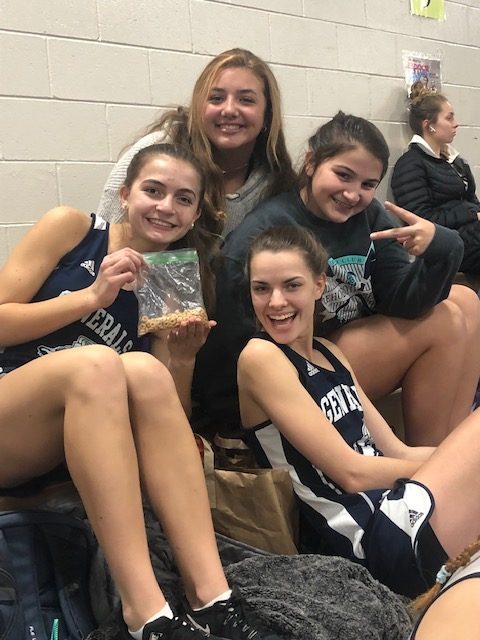 Indoor track girls are having fun during downtime of the relay meet. Top left, junior Maeve Folger, top right freshman Jessi Cooper, bottom left junior Gabi Cooper, and bottom right junior Gwyneth Fitzpatrick.