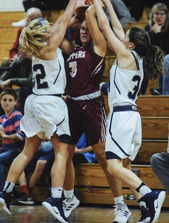 Maddy Rivers(left) jumping up to get the ball away from Newburyport