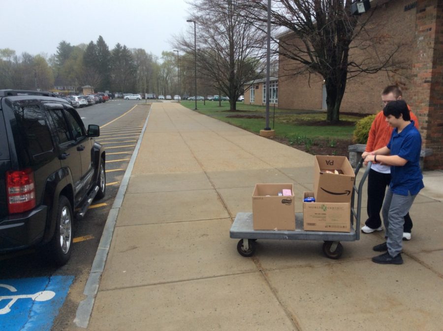 Max Vanderwilden (21) and Timothy LaBudde (21) loading the donated food into Ms. Nygrens car