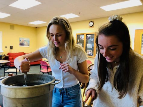Junior Emily Rooney and Maddy Rostad cooking in the teachers lounge