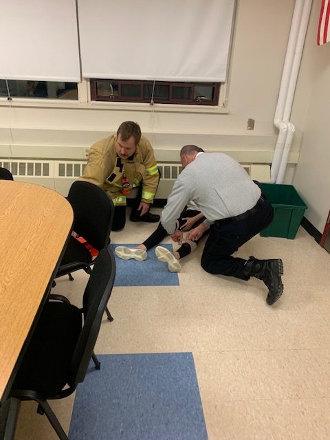 Hamilton firemen providing aid to a student volunteer 