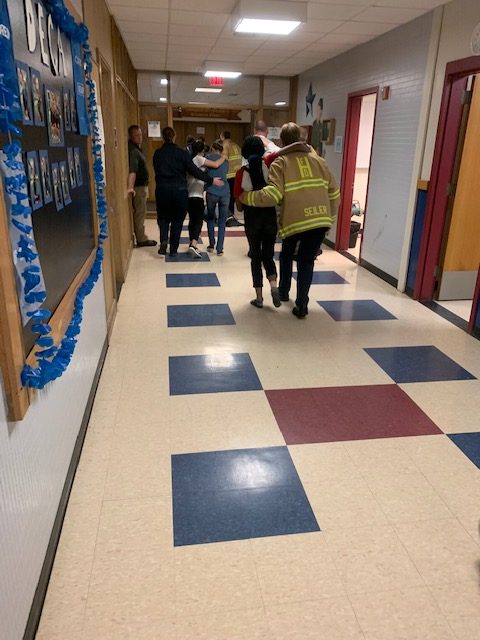 Police and Firefighters helping students get to safety