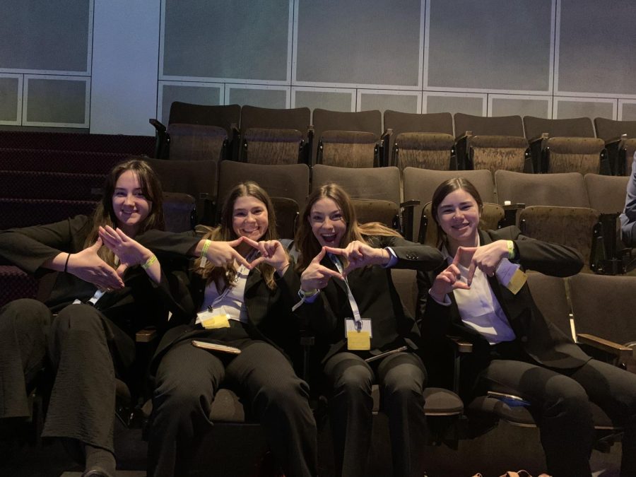 Sophomores holding up the DECA diamond while they are waiting for the final awards ceremony.