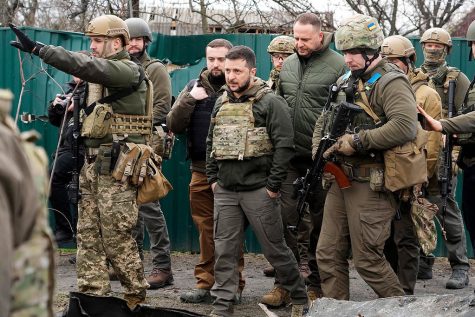 Volodymyr Zelenskyy examines the site of a recent battle