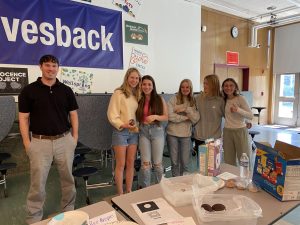 Freshmen class representatives hold a bake sale to help raise money. 