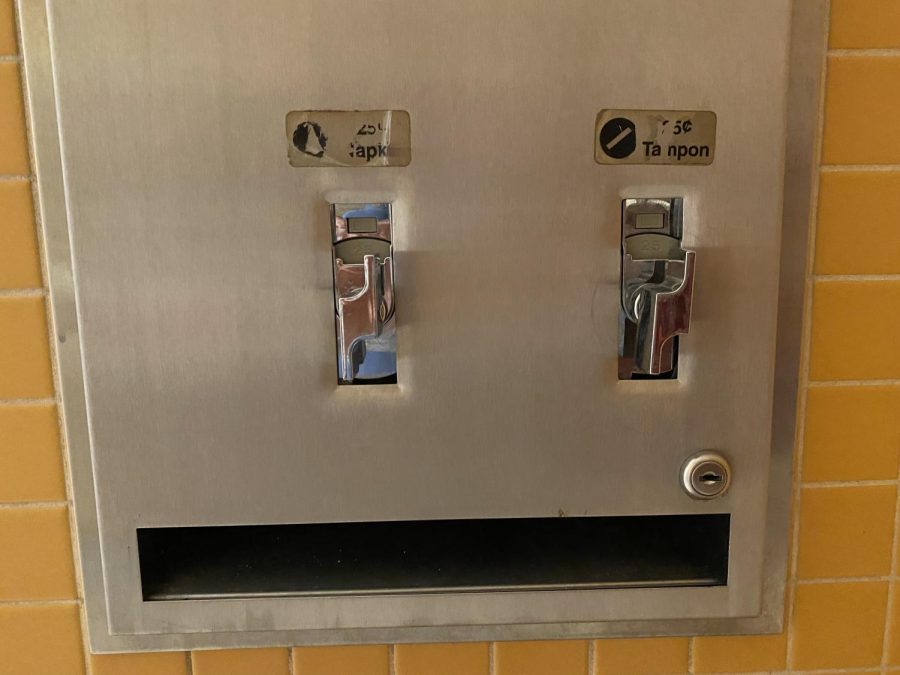 Old dispensers show a 25-cent fee for pads and tampons. September 16, 2022.