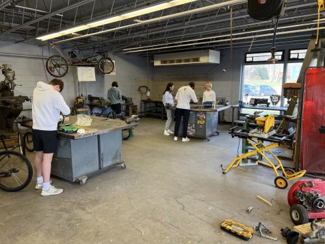 Students of the small gas engines class at work in the metal shop.