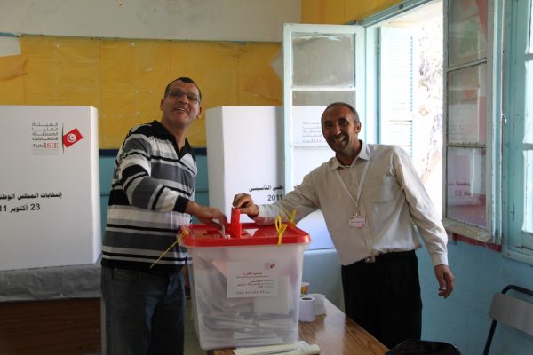 The president of the polling station and assistant seal the ballot box at a polling station in Tunisia. 