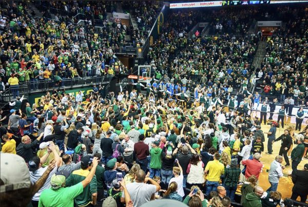 This photo shows Oregon fans storming the court after their upset win over UCLA on December 28, 2016. (Via Flickr, Drburtoni)