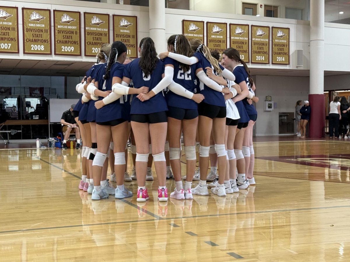 Varsity team huddle right before the game against Newburyport. 