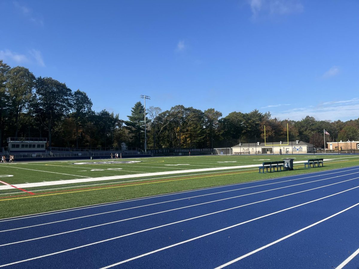 A view of the stadium field, with the new bleachers and the new amenities building. 