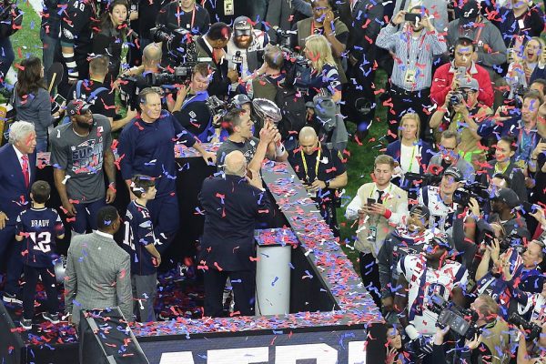 Patriots quarterback Tom Brady, center, holds up Vince Lombardi trophy after defeating the Atlanta Falcons in Superbowl 51.  